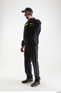 Sam Atkins Fireman with Mobilphone standing talking whole body 0002.jpg